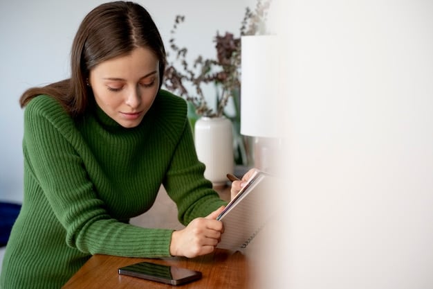 A person meticulously planning their budget and expenses on a notepad, with a credit card and a calculator placed nearby.