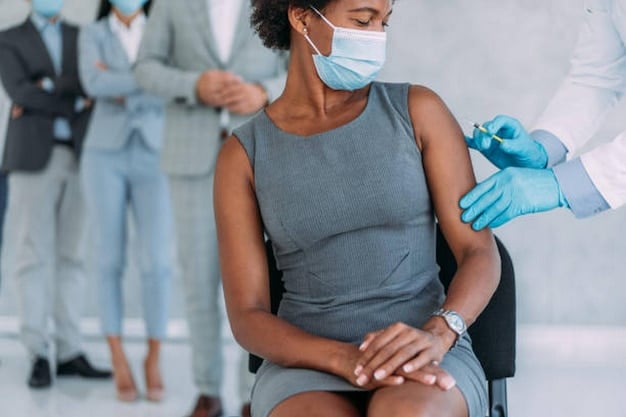 A close-up shot of a doctor administering a vaccine to a patient. The setting is sterile and professional, emphasizing the importance of pre-travel medical consultations and vaccinations.