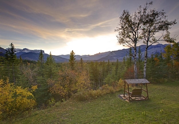 A serene campsite at dusk in a less crowded part of Grand Teton National Park, showcasing the peaceful atmosphere and stunning mountain views.