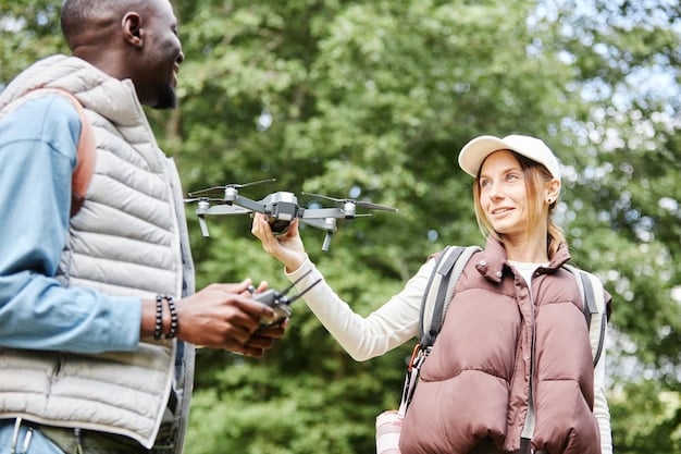 A park ranger is explaining drone regulations to a group of tourists near the entrance of the Grand Canyon National Park. The ranger is pointing to an informational sign about drone usage, and the group is listening attentively. The Grand Canyon is visible in the background.
