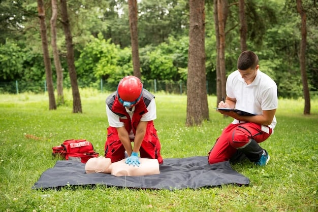A park ranger demonstrating CPR techniques on a mannequin in a training session at Grand Canyon National Park. The ranger is kneeling beside the mannequin, showing proper hand placement and compression depth. Other rangers are observing the demonstration.
