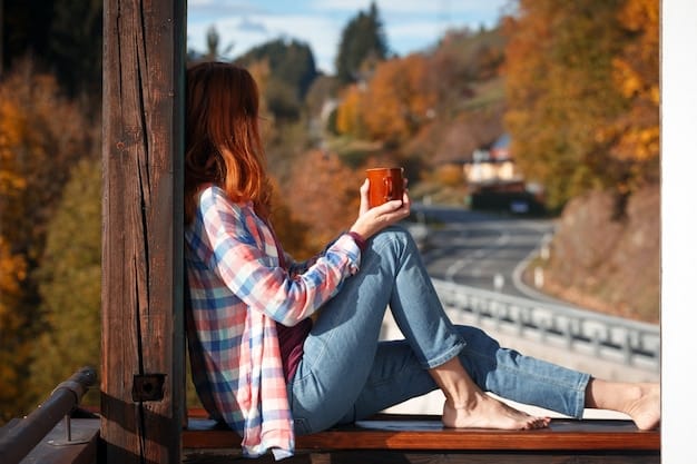 A person sitting on a porch, overlooking a forest, with no visible electronic devices. They are holding a cup of tea, enjoying nature, and looking peaceful.