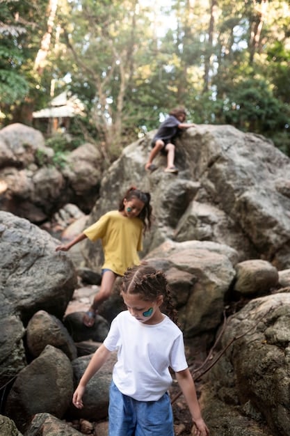 A park ranger interacting with a group of children, pointing at a specific rock formation during a guided walk in Zion National Park.