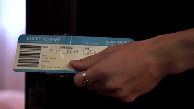 A close-up shot of a boarding pass showing the TSA PreCheck indicator. The boarding pass is held by a parent, with a child's hand visible in the background. The lighting is bright and focused on the TSA PreCheck logo.