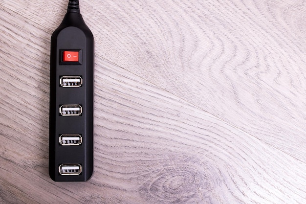 A close-up of a travel-sized portable charger with multiple USB ports, charging a smartphone and a tablet simultaneously.